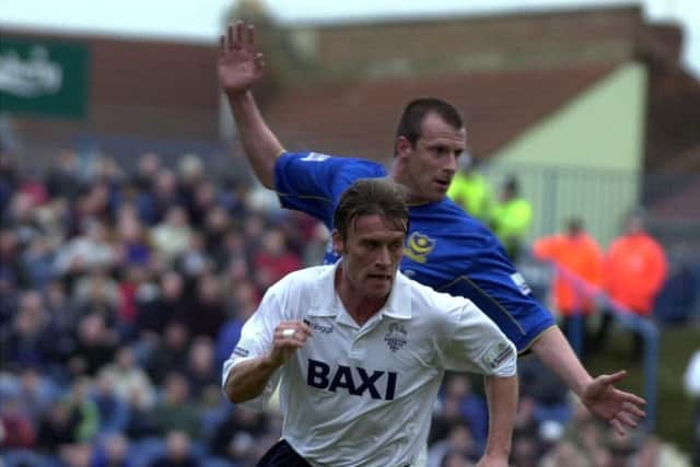 Gary Parkinson takes on Portsmouth's Steve Claridge in 2001