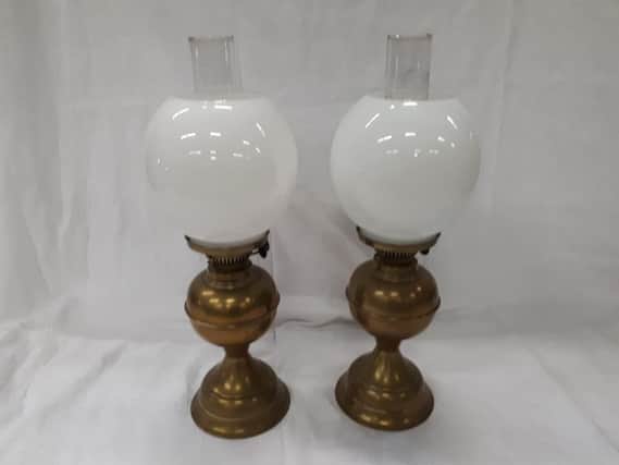 This pair of oil lamps are in good working order and on sale for 45
