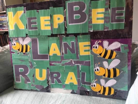 A Keep Bee Lane Rural sign