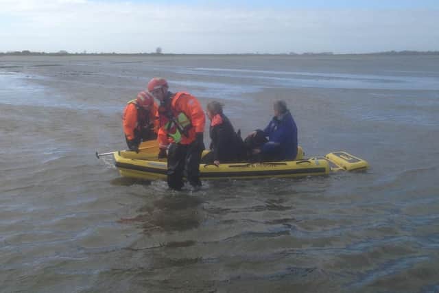 Firefighters soon arrived and launched a water rescue mission using an inflatable sledge to reach the women. Pic - Chris Kelly and Peter Kenworthy
