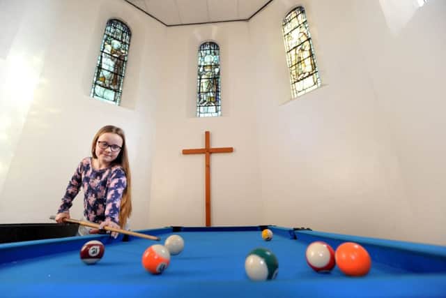 Hannah  plays pool in the church