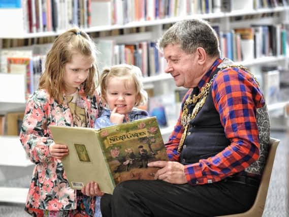 Chorley Mayor Mark Perks reads a story to Aurora (6) and Jessica (3) Johnson at last year's festival