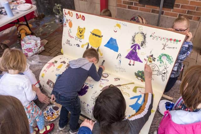 Children decorating a bench for Whats Your Story, Chorley?