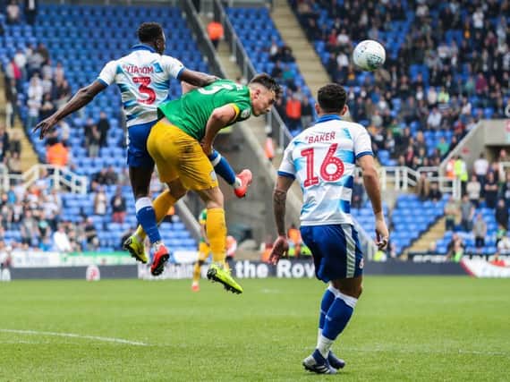 Preston left-back Josh Earl challenges in the air at Reading
