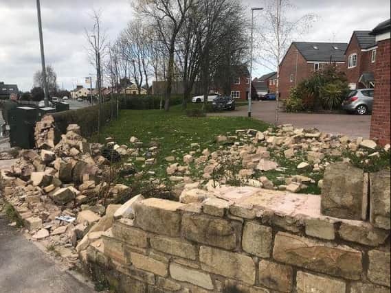 The smashed wall after being hit by a car
