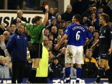 Eddie Wolstenholme, refereeing in the Premier League, gives Everton defender David Unsworth his marching orders after issuing him with a red card.