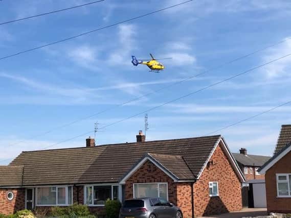 The air ambulance over the rooftops of Longton on Saturday morning
