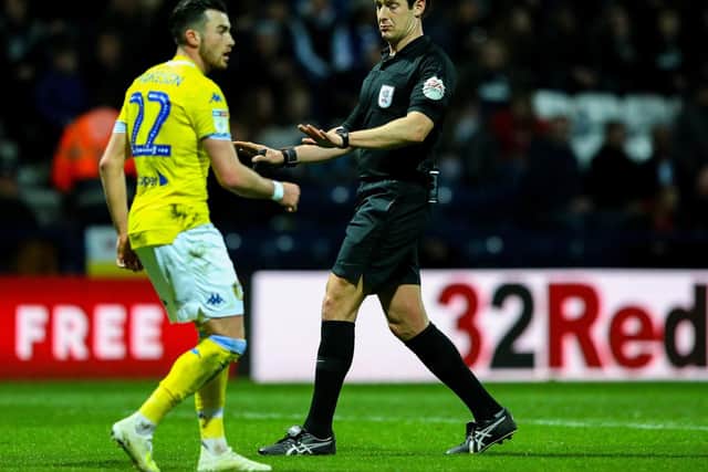 Referee Robert Jones has a word with Leeds winger Jack Harrison at Deepdale