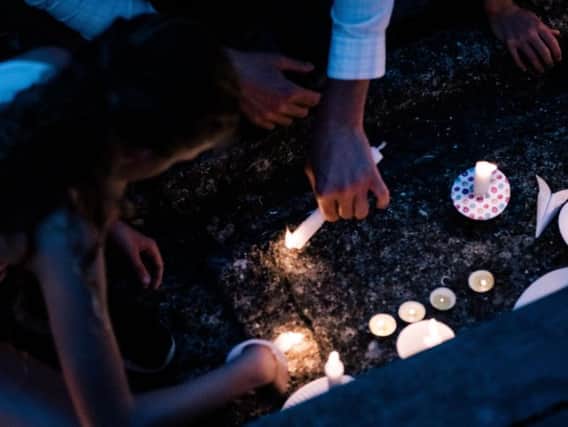Candles were lit as people attend a vigil for the lives taken in the Christchurch terror attacks in Auckland, New Zealand.  (Photo by Cam McLaren/Getty Images