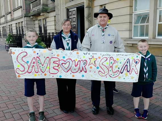 Alistair Lawless, Natalie Lawless (beaver scout leader), Ian Walls (group scout leader) and Leo Lawless outside County Hall