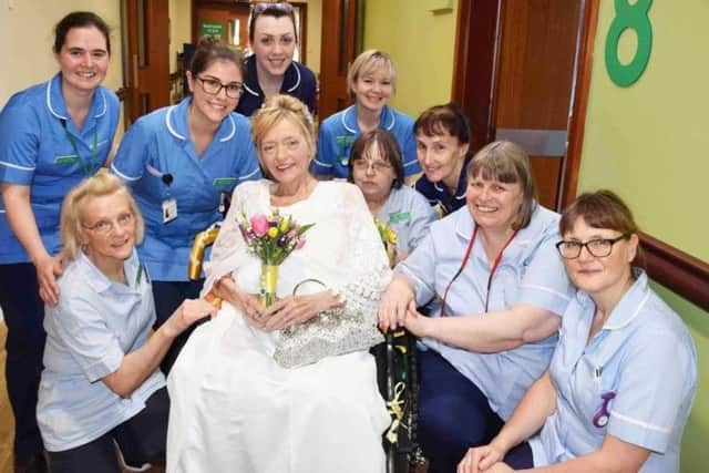 Lorraine Chambers and Chris Davey married at St Catherines Hospice. Lorraine is pictured with the hospice staff who helped on the day.