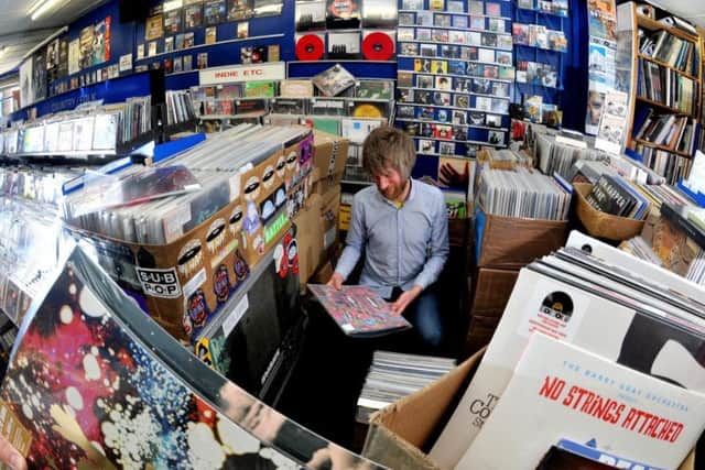 Action Records employee Ben Fuller among the vinyl