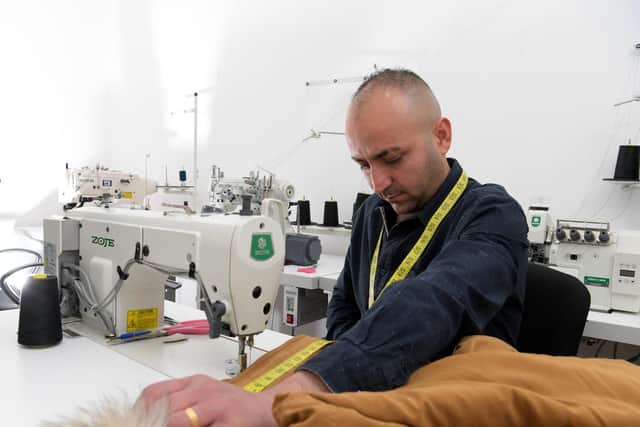Syrian refugee Jed Rached in his new tailor shop in Preston