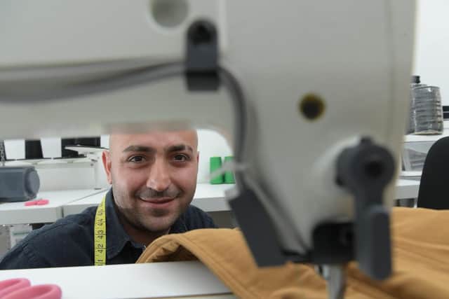 Syrian refugee Jed Rached in his new tailor shop in Preston