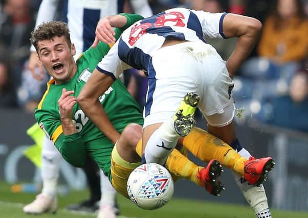 Preston midfielder Ryan Ledson slides in for a challenge against West Bromwich Albion