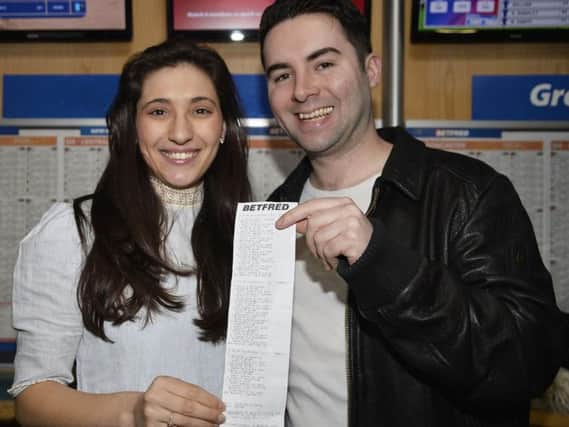 Craig and fiancee Harriet show off the winning betting slip.