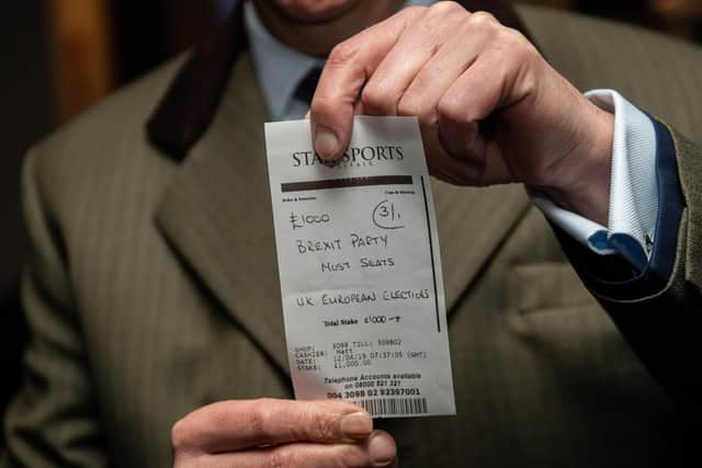 Brexit Party leader, Nigel Farage, holds a betting slip after placing a 1000 bet on his party to win the most seats during the UK European elections (Photo by Chris J Ratcliffe/Getty Images)