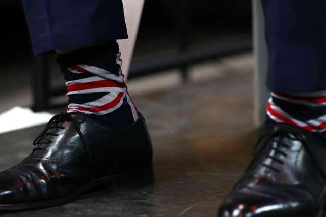 Nigel Farage wears Union Jack socks during the launch of the Brexit Party (Photo by Matthew Lewis/Getty Images)