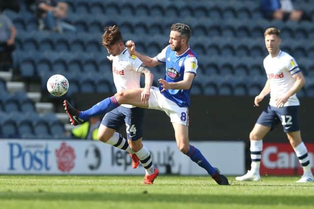 Preston's Sean Maguire battles for possession against Ipswich midfielder Cole Skuse at Deepdale