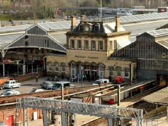 Two men from Blackburn have been charged with assaulting a police officer at Preston Railway Station on Easter Sunday.