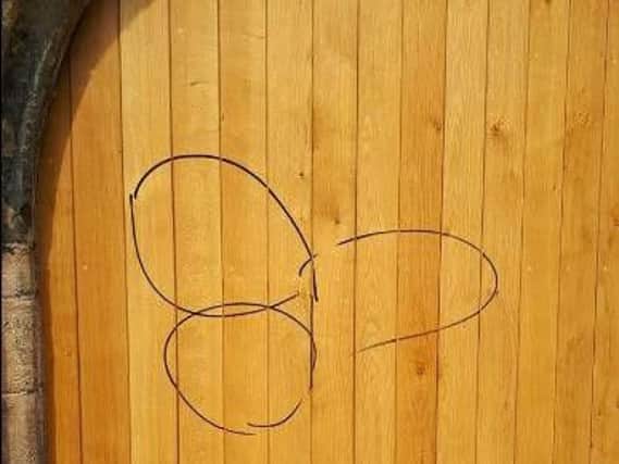 The graffiti attack on the church door