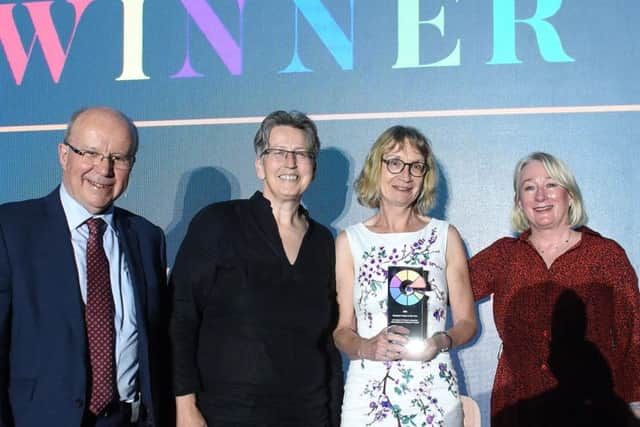 UCLan's Dr Cath Larkins and Dr Candice Satchwell (both centre) collecting the Research Project of the Year trophy.