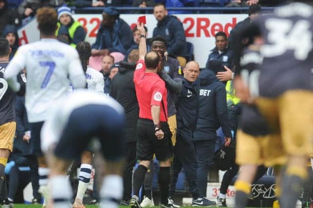 Referee Jeremy Simpson shows the red to Sheffield Wednesday right-back Dominic Iorfa at Deepdale