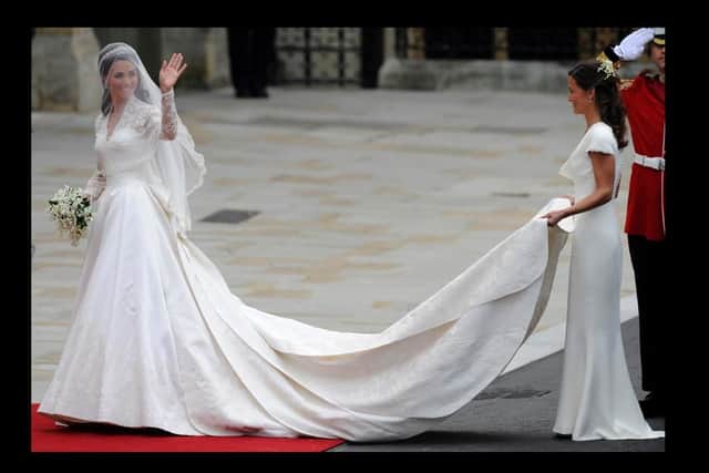 Kate Middleton waves as she arrives at the West Door of Westminster Abbey