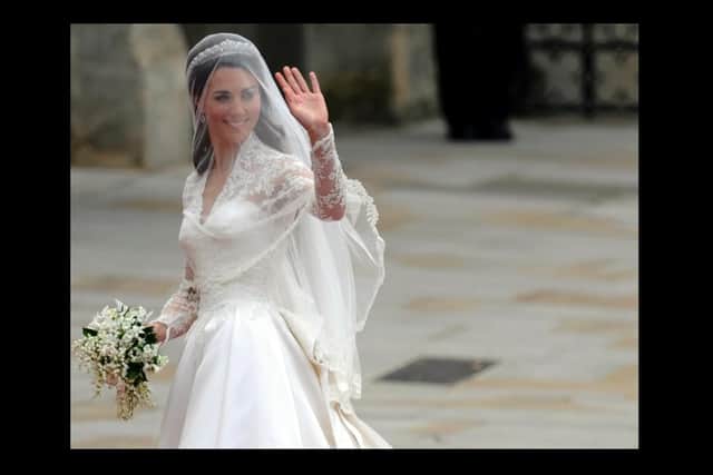 Kate Middleton waves as she arrives at the West Door of Westminster Abbey in London