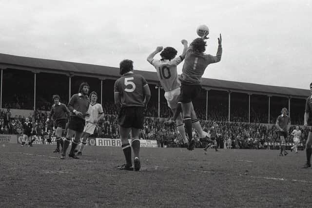 Preston striker Mike Elwiss challenges with Gillingham goalkeeper Ron Hillyard for a cross