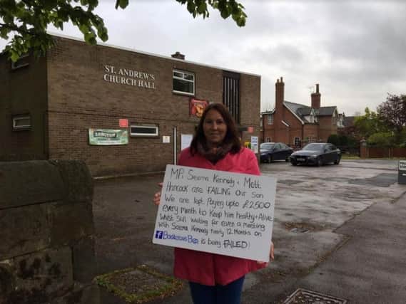 Joanne Griffiths protesting outside Longton's polling station, claiming the Tory Government has let down her son Ben.