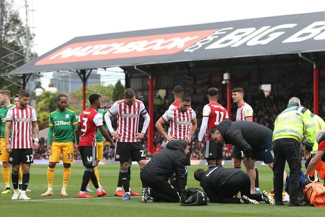 Brentford defender Julian Jeanvier received lengthy treatment after suffering a head injury in a clash with Jayden Stockley