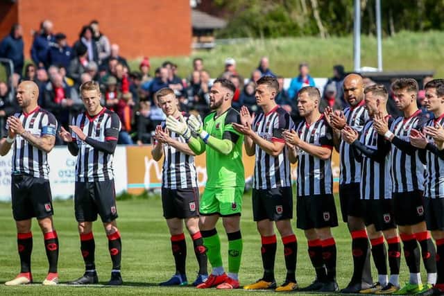 The Chorley players start the minute's applause