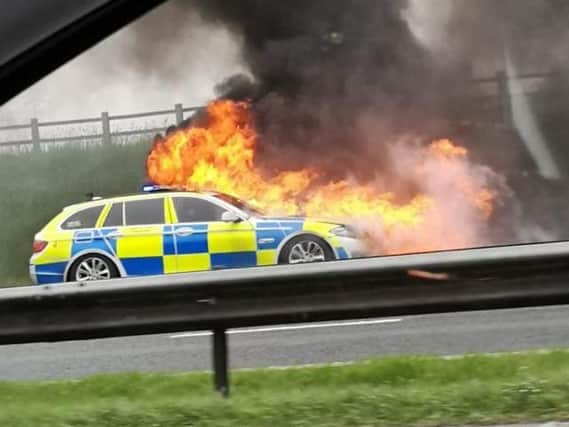 A police car has caught fire on the M6 between junctions 32 and 33 at Broughton. Credit - Sharron (@peapodlets)