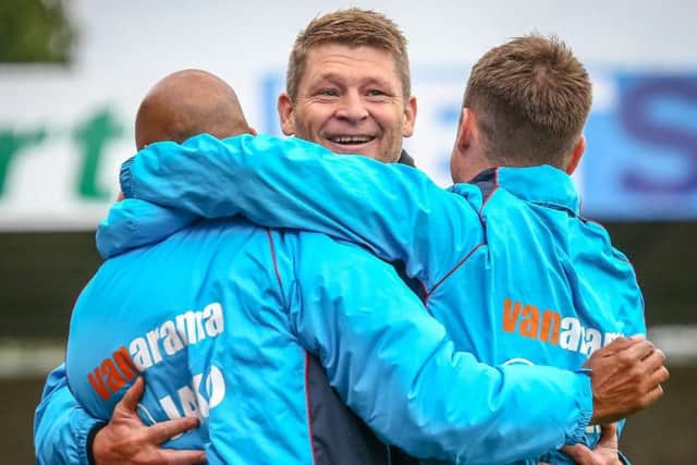 Smith celebrates the play-off semi-final win with boss Jamie Vermiglio (right) and first-team coach Andy Preece (left)