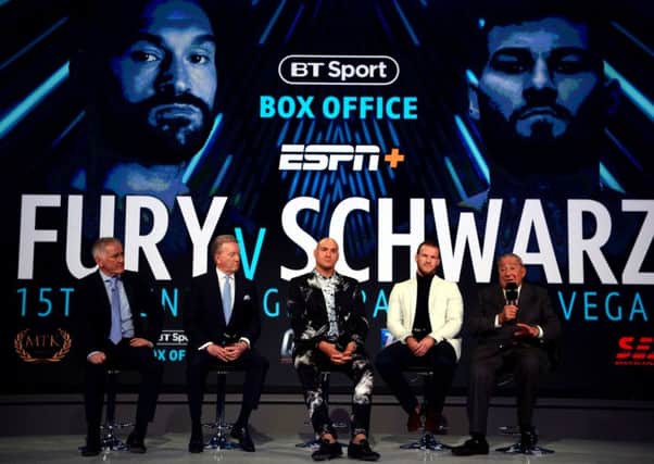 Tyson Fury (centre) with (from left to right) commentator John Rawling, promoter Frank Warren, trainer Ben Davison and promoter Bob Arum at Monday's press conference