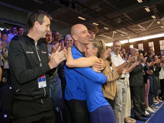Laura Massaro hugs her husband Danny following her retirement from squash
