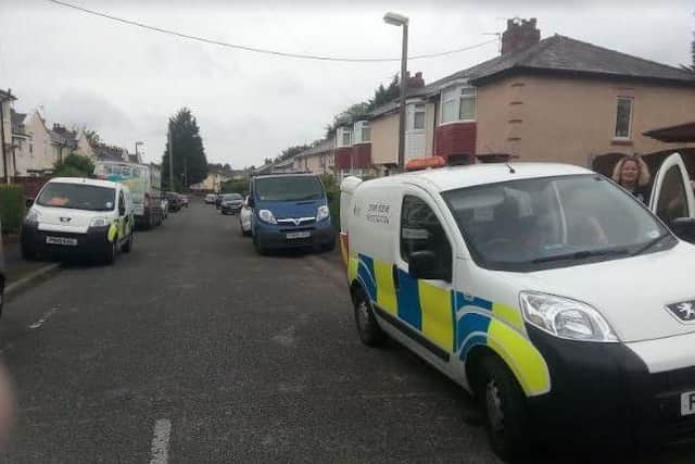 Police forensic vans outside the property on Raven Street, Deepdale.