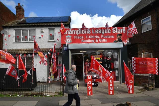 A shop sells Liverpool merchandise for the upcoming Champions League final in Liverpool (ANTHONY DEVLIN/AFP/Getty Images)