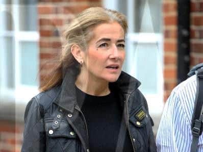 Emma Langford, 47, leaves Uxbridge Magistrates Court, after appearing accused of drunkenly assaulting three people aboard a British Airways flight.