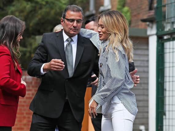 Andy Thalassitis, father of Mike Thalassitis, hugs Montana Brown, a contestant on the 2017 series of Love Island, outside Barnet Coroner's Court as the inquest into the death of Mike Thalassitis opens.