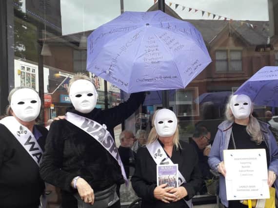 Silent Waspi protestors outside The Coffee Club in Market Street, Chorley
