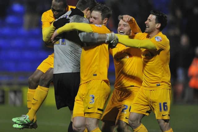 Thorsten Stuckmann is congratulated by his Preston team-mates after scoring the winning penalty at Oldham
