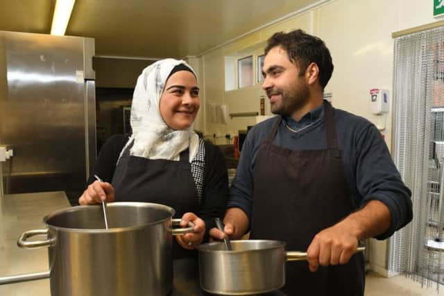 Husband and wife Safaa Shoufan and Mouhamad Kbisi in the kitchen