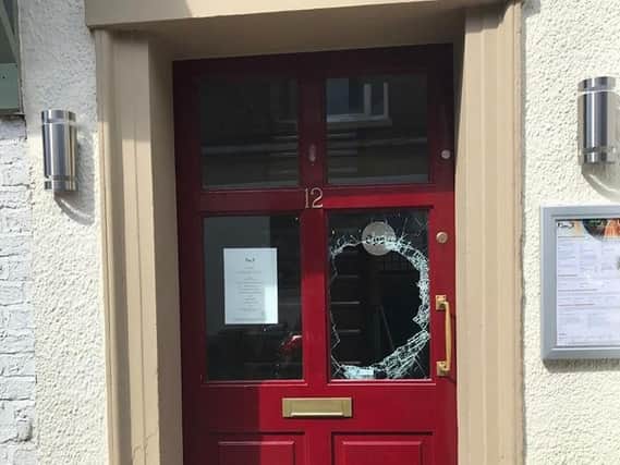 The door of the Korean restaurant in Winckley Street was smashed in the burglary. Owner of KimJi Sam Chen has now had the glass panel fixed.