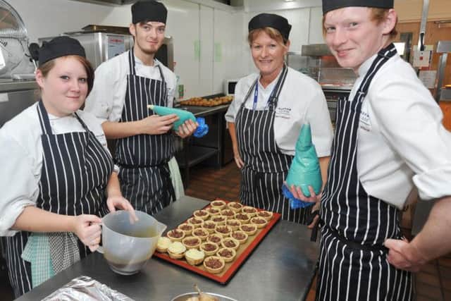 Flashback: former students at work in the kitchen at Foxholes