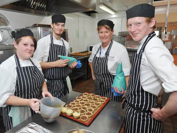 Flashback: former students at work in the kitchen at Foxholes