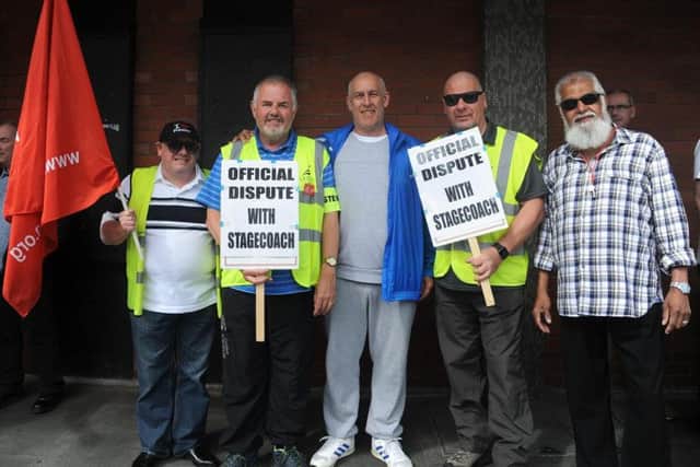 Stagecoach bus drivers striking outside Preston bus station. Strikers with UNITE Branch Secretary Peter Winstanley (left holding placard) and Chairman Gary Campion (right with placard). (JPIMedia)
