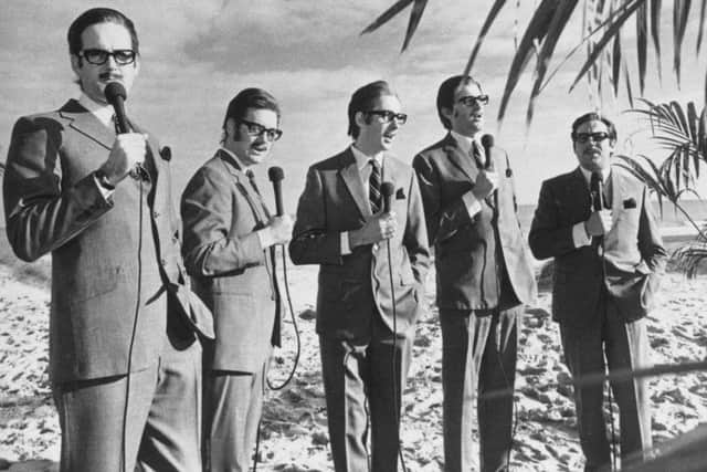 The Monty Python team imitate journalist and broadcaster Alan Whicker. Left to right: John Cleese, Michael Palin, Eric Idle, Graham Chapman (1941 - 1989) and Terry Jones