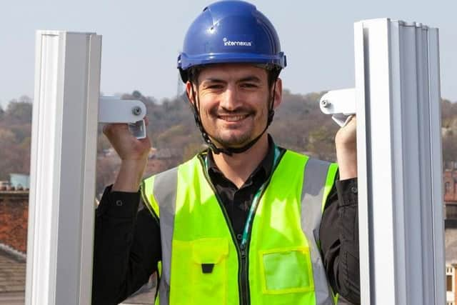 Neil Knighton, communications manager for Internexus, shows off the wireless transmitters that will provide Preston's ultra-fast internet